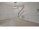 Open dining room featuring a modern chandelier and stairs to upper level at 497 Summerwalk Cir # 497, Chapel Hill, NC 27517