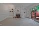 Bright living room featuring a fireplace, built-in shelves, and sliding doors to the outdoor patio at 497 Summerwalk Cir # 497, Chapel Hill, NC 27517