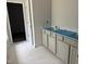 Bathroom featuring marble floors, gray cabinets, and a white countertop at 5516 Jaeger Dr # 75, Graham, NC 27253