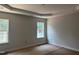 Cozy bedroom with two large windows bringing in natural light, and neutral paint ready for customization at 5516 Jaeger Dr # 75, Graham, NC 27253