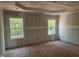 Unfinished main bedroom with a tray ceiling and large windows at 5516 Jaeger Dr # 75, Graham, NC 27253