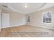 Bedroom featuring hardwood floors, tray ceiling and natural light at 5516 Jaeger Dr # 75, Graham, NC 27253