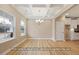 Elegant dining room with tray ceilings, light hardwood floors, and ample natural light at 5516 Jaeger Dr # 75, Graham, NC 27253