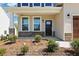 Inviting entrance with stone accents and a stylish front door, complemented by lush landscaping at 5516 Jaeger Dr # 75, Graham, NC 27253