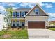 Charming two-story home featuring a spacious two-car garage and a well-manicured lawn at 5516 Jaeger Dr # 75, Graham, NC 27253