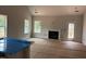 Living room with fireplace, windows and light from door leading to deck under construction, and adjacent to kitchen island at 5516 Jaeger Dr # 75, Graham, NC 27253