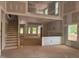 Unfinished living room featuring large windows, a staircase, and an open floorplan at 5516 Jaeger Dr # 75, Graham, NC 27253