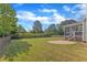 Spacious backyard offering a serene setting with lush greenery, a stone patio, and privacy fencing at 602 Alden Bridge Dr, Cary, NC 27519