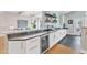 Wet bar with wine refrigerator, built-in shelving, granite countertop, and sink at 602 Alden Bridge Dr, Cary, NC 27519