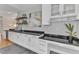 Bar with granite countertops, undercounter refrigerator, upper shelving, and adjacent desk area at 602 Alden Bridge Dr, Cary, NC 27519