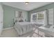 Cozy bedroom with neutral decor, a large window, and a white desk at 602 Alden Bridge Dr, Cary, NC 27519