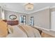 Well-lit bedroom featuring a chandelier, neutral walls, and sliding closet door at 602 Alden Bridge Dr, Cary, NC 27519