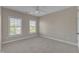 Spacious bedroom featuring neutral walls, carpet, natural light from two windows, and a ceiling fan at 602 Alden Bridge Dr, Cary, NC 27519