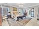 Bright bedroom with a decorative chandelier, patterned rug, and neutral decor at 602 Alden Bridge Dr, Cary, NC 27519