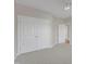 Bright bedroom with neutral walls, carpet, ceiling fan, closet, and entry to the rest of the house at 602 Alden Bridge Dr, Cary, NC 27519