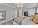 Bright bedroom featuring neutral walls, a large rug, and a double closet at 602 Alden Bridge Dr, Cary, NC 27519