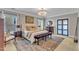 Bright bedroom with a decorative chandelier, patterned rug, and neutral decor at 602 Alden Bridge Dr, Cary, NC 27519