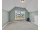 Bonus room with neutral paint, carpet floors, and a window overlooking the front yard at 602 Alden Bridge Dr, Cary, NC 27519