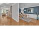 Open-concept dining room with blue accent wall, hardwood floors, and modern decor at 602 Alden Bridge Dr, Cary, NC 27519