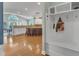 Spacious entryway featuring wood floors, custom mudroom nook and a view of the kitchen with breakfast bar seating at 602 Alden Bridge Dr, Cary, NC 27519
