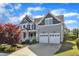 Side view of a two-story house featuring an attached garage and landscaped lawn at 602 Alden Bridge Dr, Cary, NC 27519