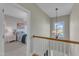 Hallway featuring hardwood flooring, chandelier, and staircase with view into furnished bedroom at 602 Alden Bridge Dr, Cary, NC 27519