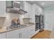 Updated kitchen with stainless appliances, granite counters, gas cooktop, and tile backsplash at 602 Alden Bridge Dr, Cary, NC 27519