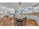 Bright, open kitchen with granite countertops, large island, stainless steel appliances, and hardwood floors at 602 Alden Bridge Dr, Cary, NC 27519