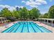 A well-maintained community lap pool with lane markers surrounded by trees at 602 Alden Bridge Dr, Cary, NC 27519