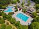 Aerial view of a community pool featuring lap lanes, a circular pool, waterslide, sun deck, and ample seating areas for residents at 602 Alden Bridge Dr, Cary, NC 27519