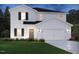 Charming two-story home with a landscaped yard and a two-car garage at 613 White Birch Ln, Angier, NC 27501