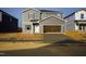 New construction home featuring a two-car garage in a developing neighborhood at 613 White Birch Ln, Angier, NC 27501