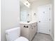 Bathroom featuring grey vanity, toilet, and dark hardware at 63 Whistling Duck Way, Wendell, NC 27591