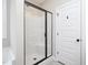 Bathroom featuring tiled flooring, glass door shower, and soaking tub with a window at 63 Whistling Duck Way, Wendell, NC 27591