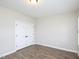 Neutral bedroom has a double-door closet and modern hardwood floors at 63 Whistling Duck Way, Wendell, NC 27591