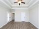 Bright bedroom with plank flooring and double french doors leading to a screened porch at 63 Whistling Duck Way, Wendell, NC 27591