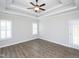 Bright bedroom with plank flooring, recessed lighting, and double french door at 63 Whistling Duck Way, Wendell, NC 27591