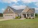 Attractive home with a well-maintained lawn, attached two car garage and appealing architectural details at 63 Whistling Duck Way, Wendell, NC 27591