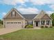 Charming single Gathering home featuring a manicured lawn, two car garage, and inviting front entrance at 63 Whistling Duck Way, Wendell, NC 27591