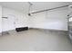 A bright, clean garage space with epoxy flooring offering both functionality and aesthetic appeal for parking at 63 Whistling Duck Way, Wendell, NC 27591
