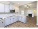 A well-lit kitchen features modern grey cabinets, stainless steel appliances and an open view to the living room at 63 Whistling Duck Way, Wendell, NC 27591