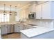 Modern kitchen features granite countertops, stainless steel appliances, and updated hardware at 63 Whistling Duck Way, Wendell, NC 27591