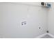 This laundry area provides essential utility connections and includes overhead shelving for organization at 63 Whistling Duck Way, Wendell, NC 27591