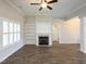 Living room boasts a cozy fireplace, built-in shelving, and wood-look floors, plus plenty of natural light at 63 Whistling Duck Way, Wendell, NC 27591