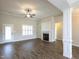Spacious living room with wood floors, fireplace and built-in shelving, and natural light at 63 Whistling Duck Way, Wendell, NC 27591