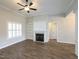 Bright living room features a fireplace, built-in shelving, plantation shutters and neutral decor at 63 Whistling Duck Way, Wendell, NC 27591