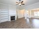 Open-concept living area has a fireplace with built-ins, and decorative columns by the front entrance at 63 Whistling Duck Way, Wendell, NC 27591