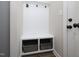 Inviting mudroom featuring a built-in bench with storage baskets, coat hooks, and convenient access to the home at 63 Whistling Duck Way, Wendell, NC 27591