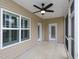 This covered patio has neutral siding, two doors, and a window for lots of natural light at 63 Whistling Duck Way, Wendell, NC 27591