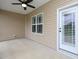 Covered patio featuring a ceiling fan, neutral siding, a door, and a window at 63 Whistling Duck Way, Wendell, NC 27591